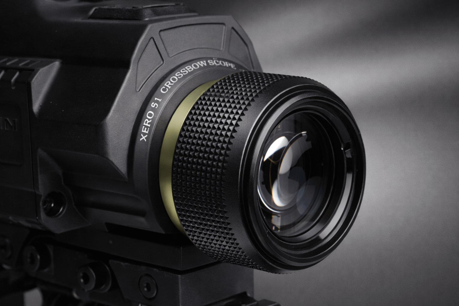 Close-up of Garmin Xero X1i knurled adjustment ring and front lens, studio lighting