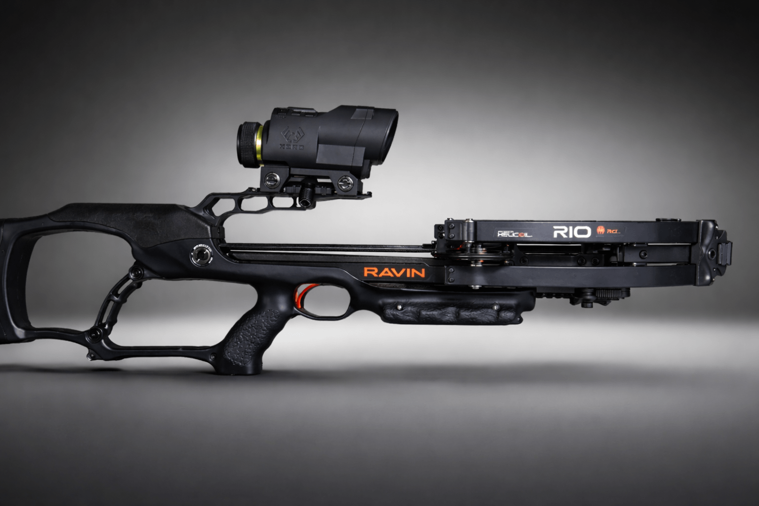 Ravin crossbow with Ravin Integrated Xero X1i scope mounted, studio lighting, gray background