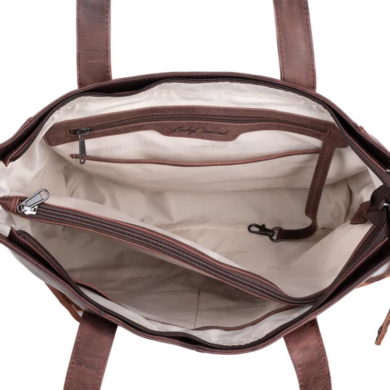 Interior view of Norah tote showing divided compartments, full-length zip divider pocket, and key strap